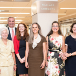 Five women and one man posing for a group photo