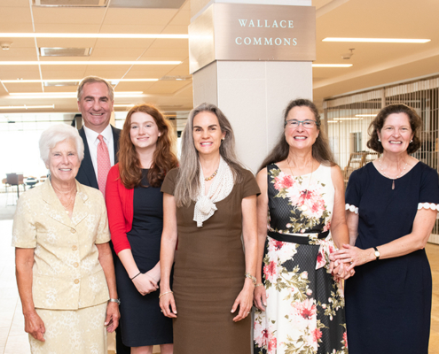Five women and one man posing for a group photo